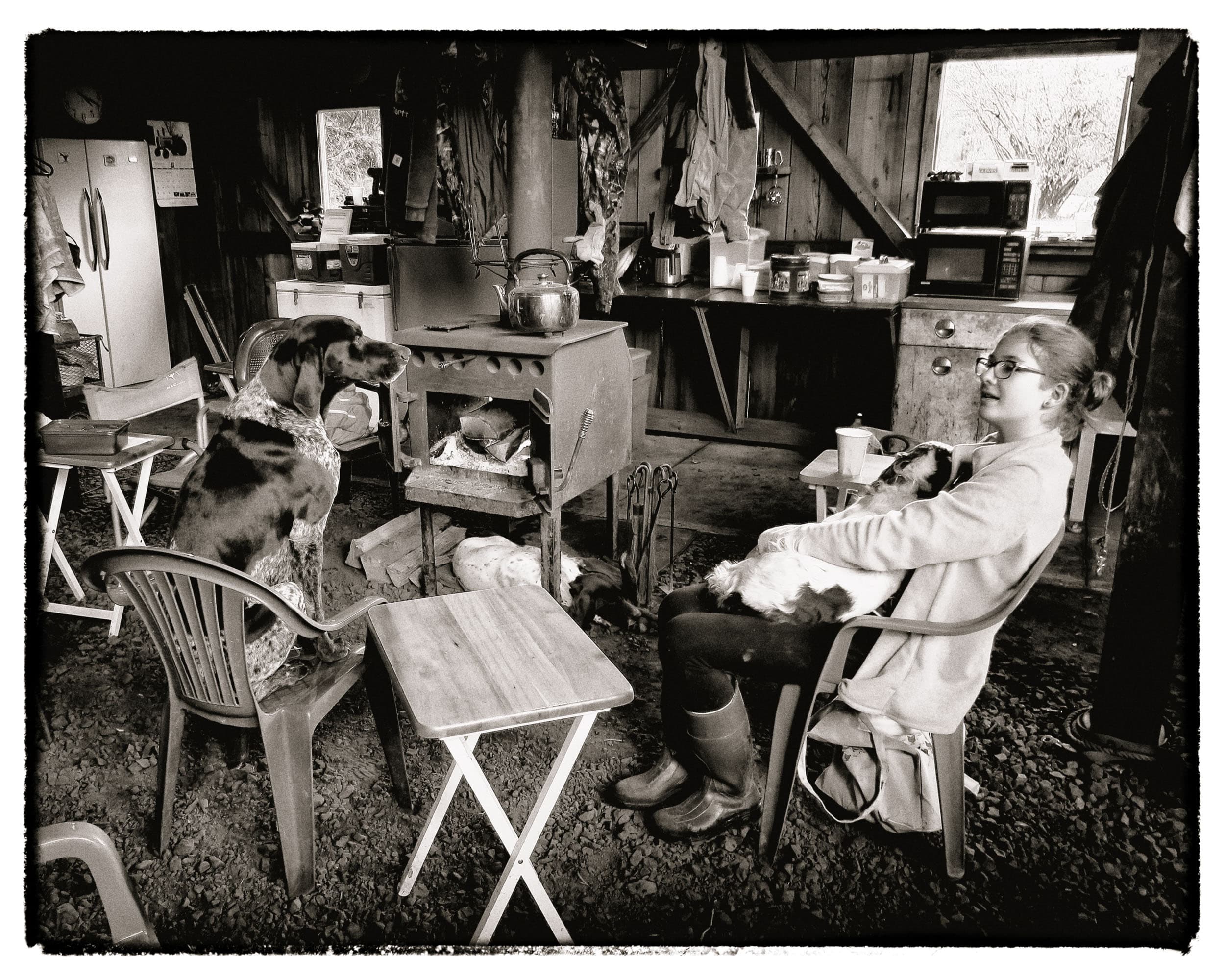 Adriana resting with her hunting dogs after a day's hunt